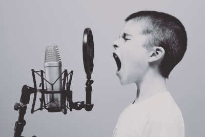 Boy singing with a microphone